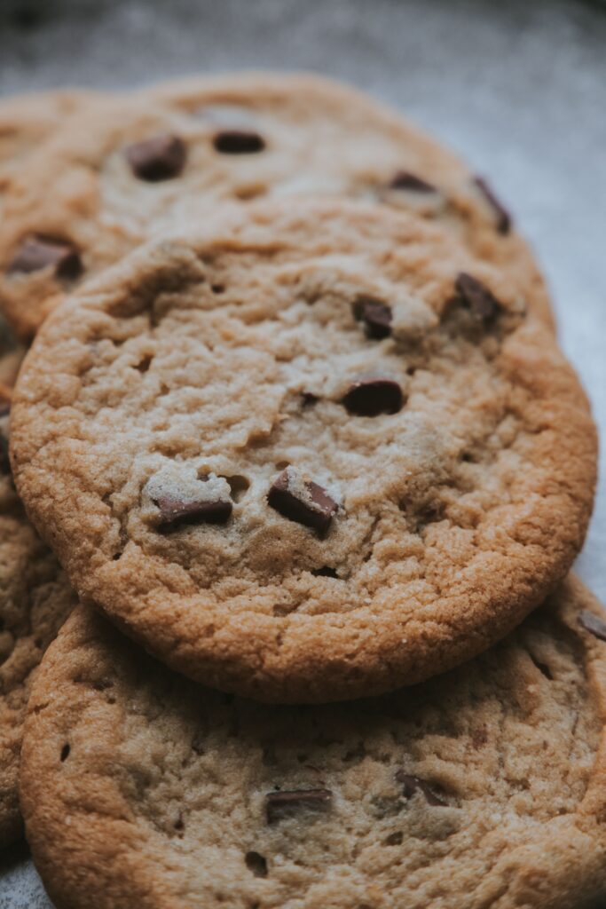 Service-1-min (1) Warm, delicious chocolate chip cookies in a close-up shot, perfect for food enthusiasts.